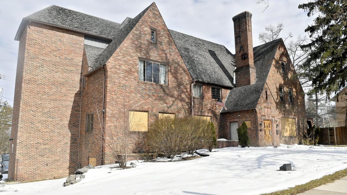 Windows are boarded up at the former Pi Lambda Phi fraternity house at 321 Fraternity Row on Wednesday. The fraternity was suspended by the university in 2017, and the house is now on the market for $990,000.