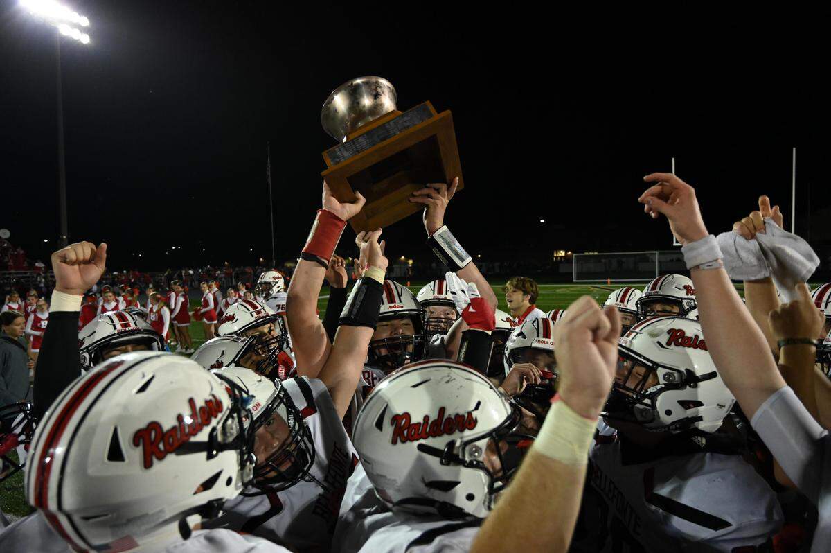 The Bellefonte Red Raiders raise the Curtin Bowl Trophy after winning the football game against Bald Eagle at Bald Eagle Area High School on Friday, Sept. 27, 2024.
