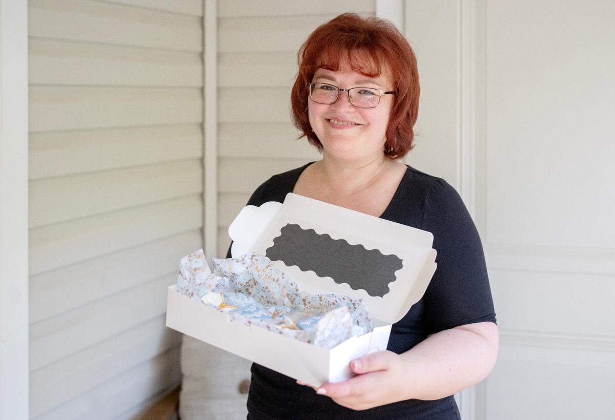Marina Stefanovich of Lady M & Co Bakery holds a box of cookies on Wednesday, June 4, 2025.