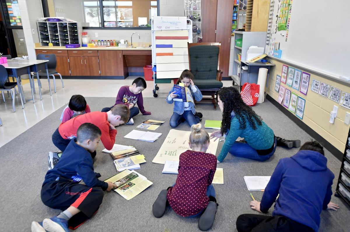 Meaghan Canavaciol works on a reading activity Friday with her third grade class in their new classroom at Corl Street Elementary School. Portions of the renovations are completed as other sections continue to be worked on.