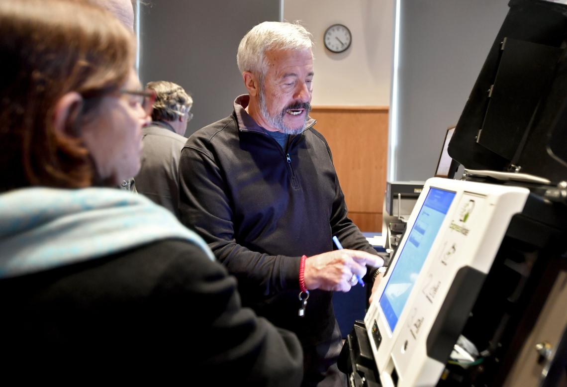 Todd Urosevich, co-founder of the company Election Systems & Software, explains an express vote machine to community members at the State College Municipal building on Nov. 29, 2018. The Pennsylvania Department of State hosted the expo to show voting machines as Pennsylvania makes the switch to paper ballot machines by 2020.