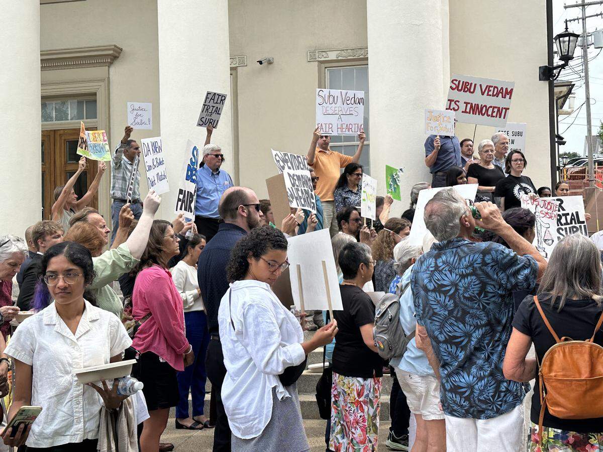 Supporters of Subramanyam Vedam hold up signs outside the Centre County Courthouse Monday, July 22, 2024.