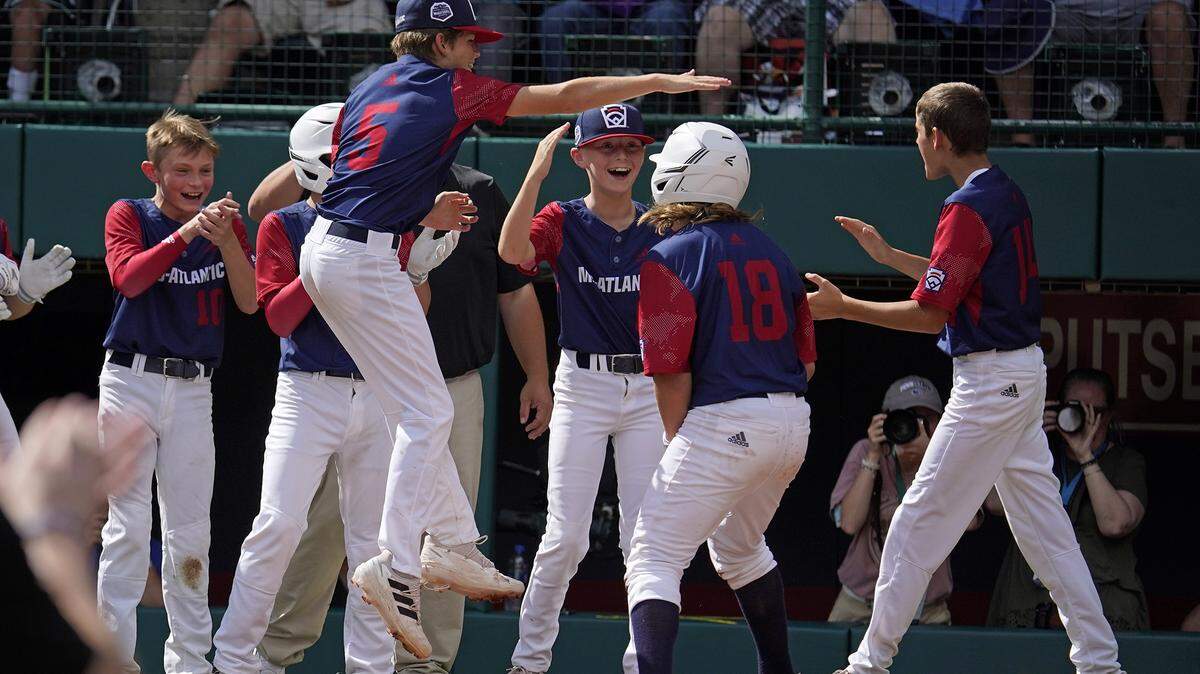 Hollidaysburg’s Chase Link (18) celebrates after crossing home plate after hitting a solo home run during the first inning of a baseball game against Hagerstown, Ind., at the Little League World Series in South Williamsport on Tuesday, Aug. 23, 2022.