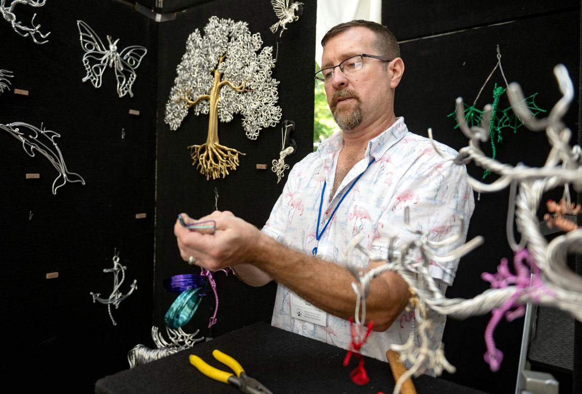 Devin Mack twists wire into a hummingbird at his booth along Pollock Road during the Central Pennsylvania Festival of the Arts on Friday, July 11, 2025.