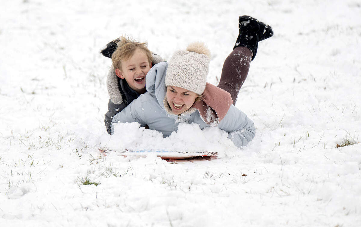 Apollo Ace laughs as he sleds down the hill with his mom Dasha at Slab Cabin Park on Tuesday, Dec. 2, 2025.