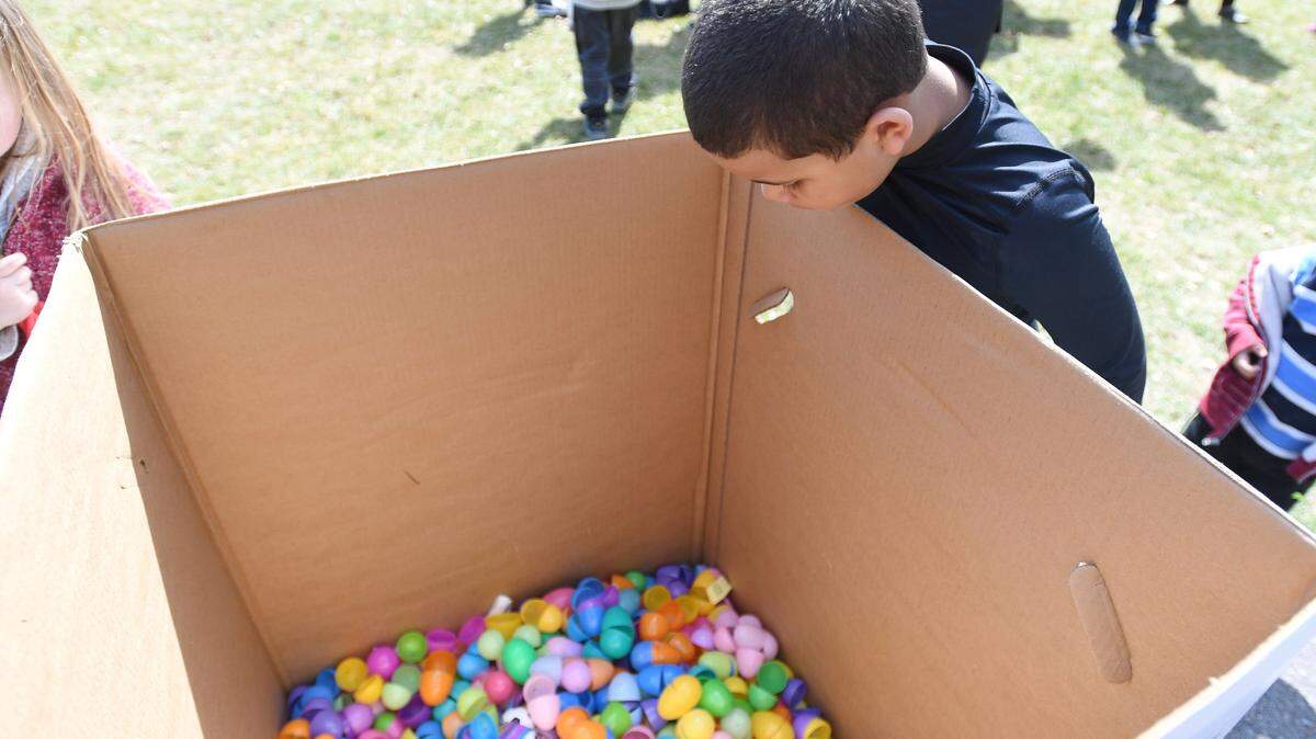Manasseh Jack peers into the Easter egg recycle box after the Bellefonte Easter Egg Hunt in March 2018 at Talleyrand Park.