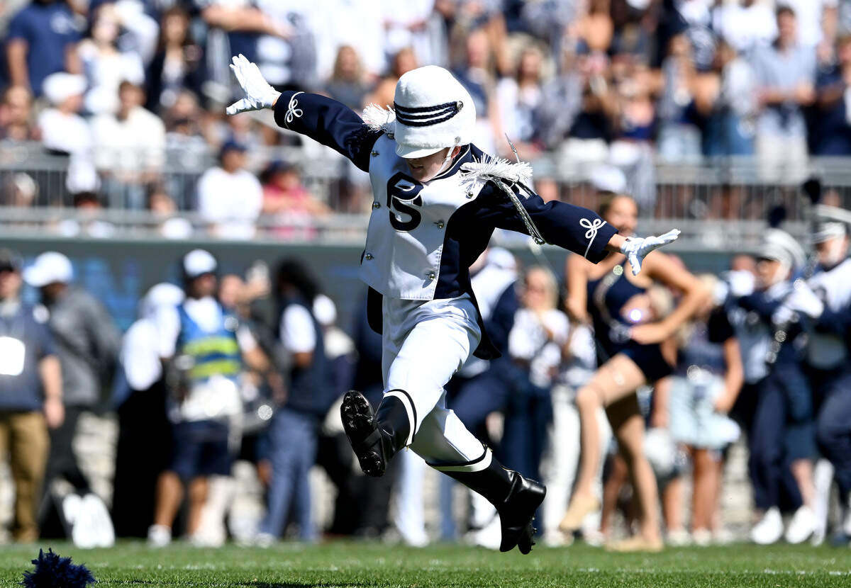 Penn State Blue Band drum major Ellie Sheehan does the first flip of the pregame show on Saturday, Aug. 30, 2025.  