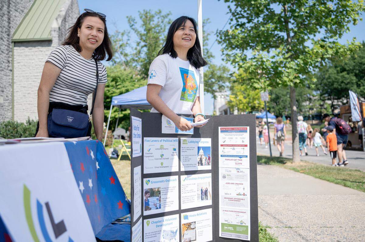 Tess Phan and Chiew Ee Kwong volunteer at the Citizen’s Climate Lobby booth on Friday, July 15, 2022. Phan from Vietnam and Kwong from Malaysia were in Centre County through the Young Southeast Asian Leaders Initiative Fellows Program.