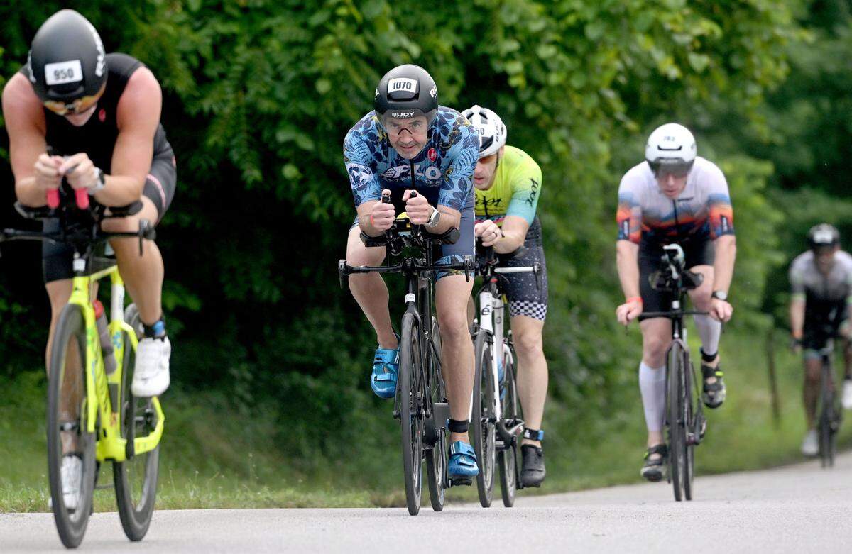 Athletes bike out of Bald Eagle State Park for the 56 mile ride in the Ironman 70.3 Pennsylvania Happy Valley on Sunday, June 30, 2024.