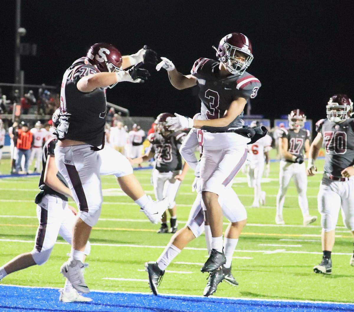 State College’s Michael Dincher (75) and Jashaun Green (3) celebrate in the end zone after scoring against Williamsport in the District 6 Class 6A championship game on Friday, Nov. 12, 2021, at Central Mountain. State College won, 17-14.