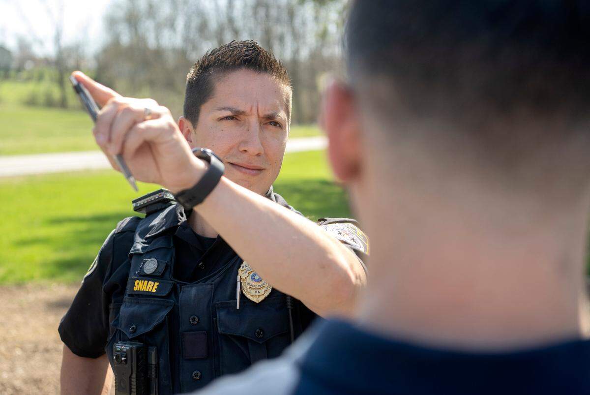Spring Township police officer Chris Snare demonstrates the horizontal gaze nystagmus test with intern Evan Gelman. The test, along with other evaluations, are part of a field sobriety test for those suspected to be driving under the influence.