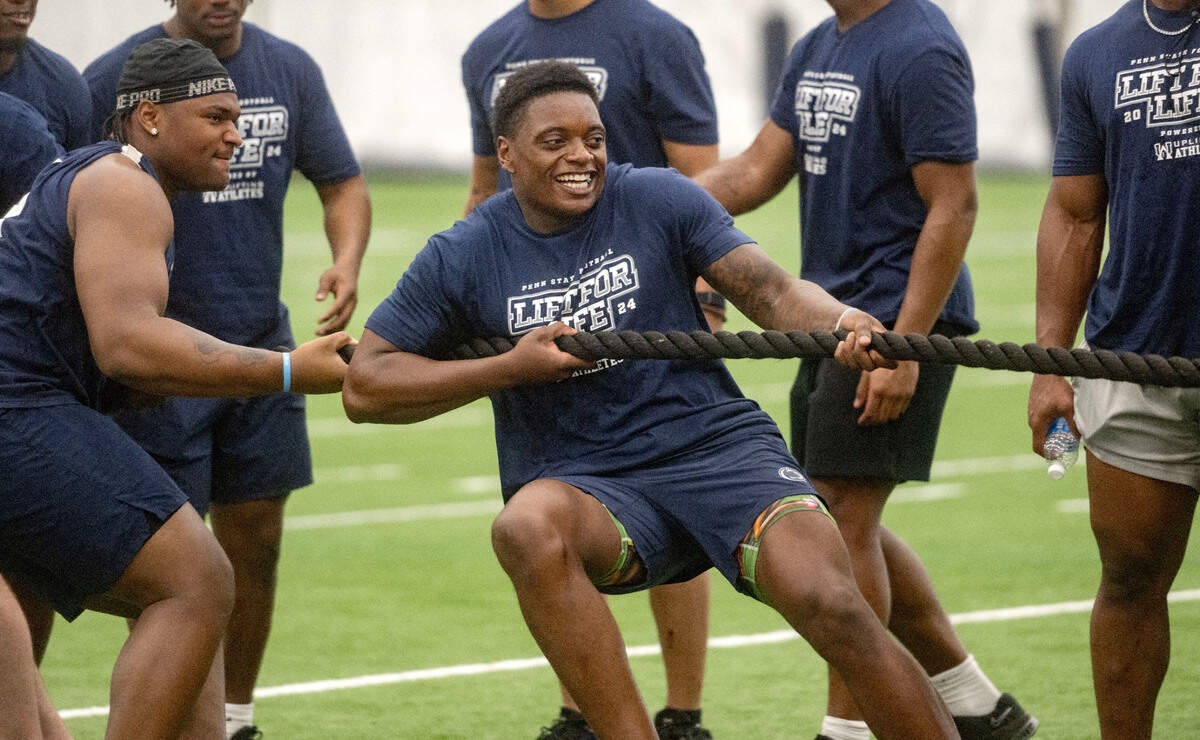 Penn State linebacker Ta’Mere Robinson laughs as he and the defense compete against the offense in tug-of-war during the 21st Annual Lift for Life to benefit Uplifting Athletes on Thursday, June 13, 2024 in Holuba Hall.