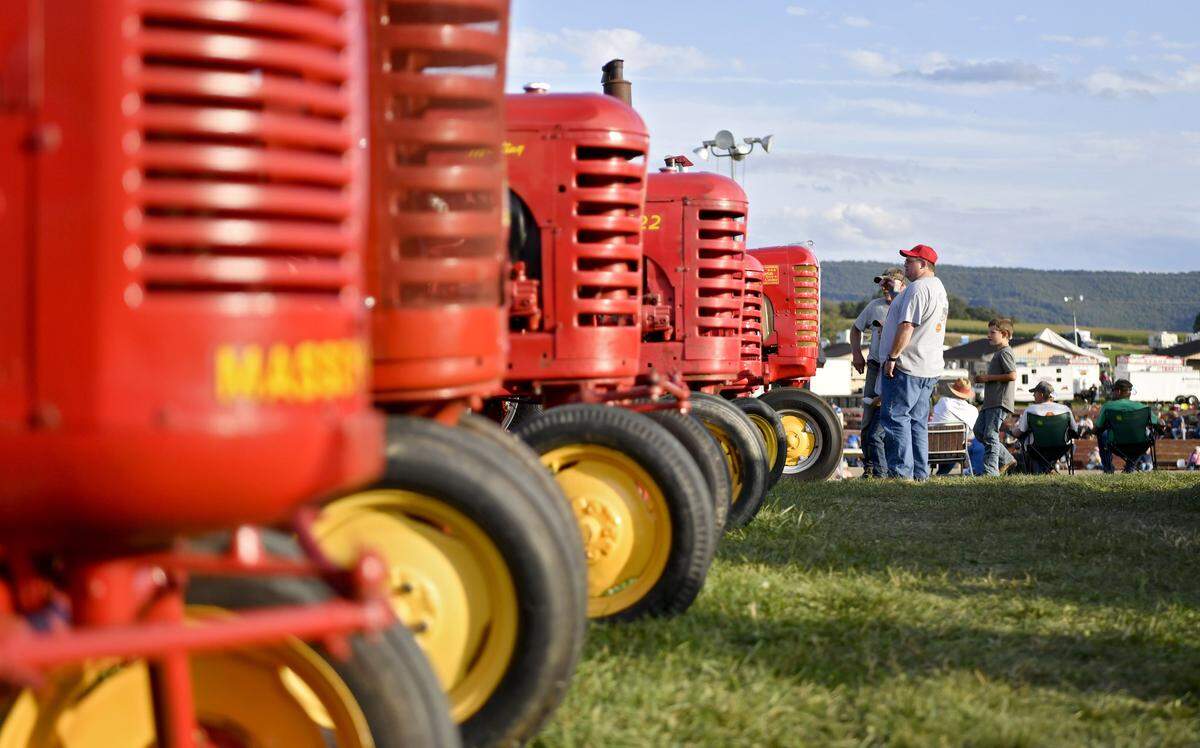 Visitors enjoy walking along the tractors at the 45th Anniversary show of the Nittany Antique Machinery Association fall show on Sept. 6, 2019 at Penn’s Cave.