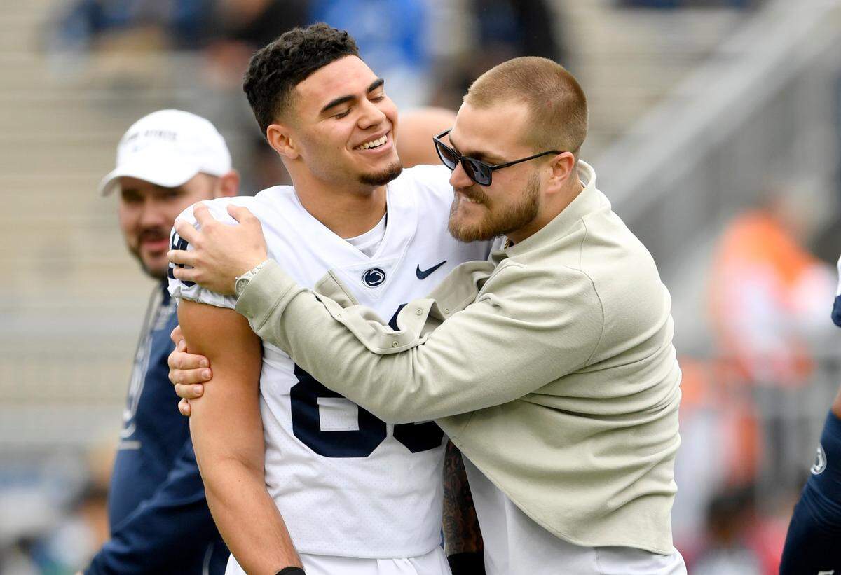 Former Penn State stand out Pat Freiermuth hugs old teammate during warmups for the Blue-White game on Saturday, April 23, 2022.