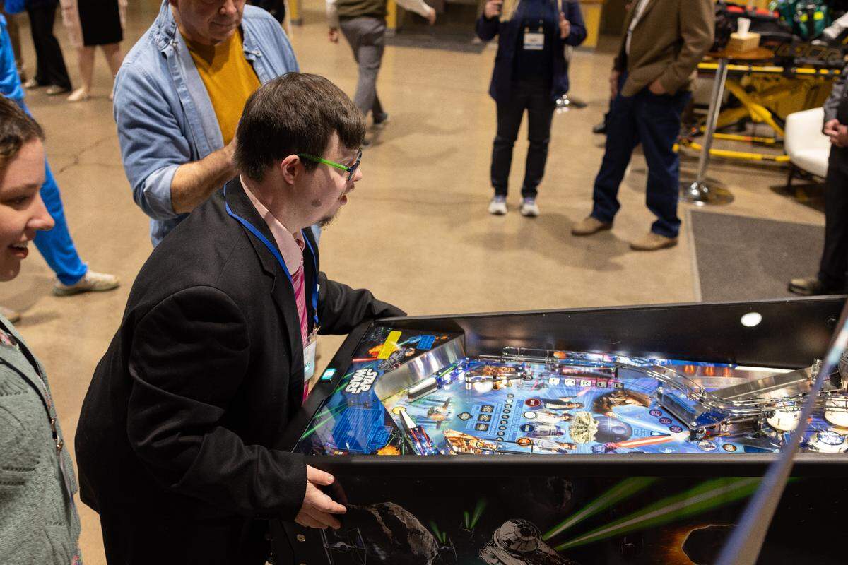 A guest plays pinball during Night to Shine on Friday, Feb. 7, 2025.