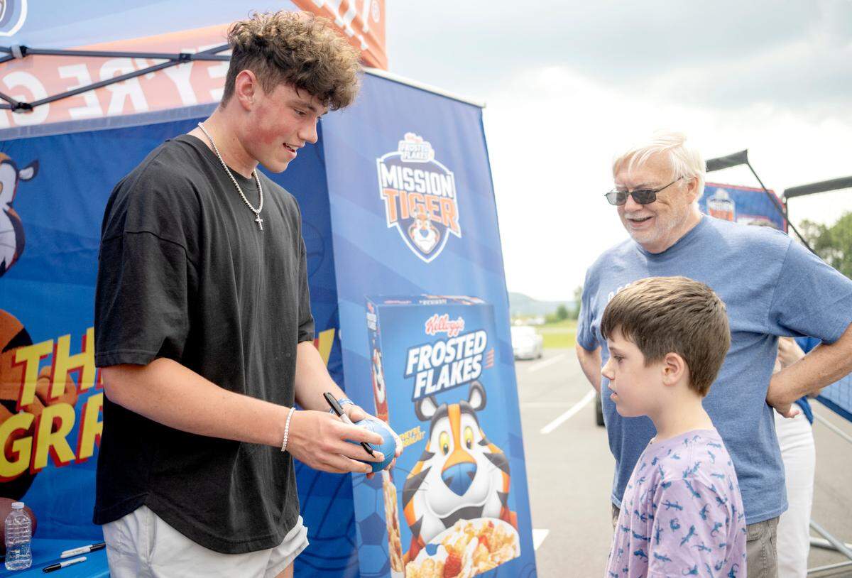 Penn State quarterback Drew Allar signs autographs for fans as he teamed up Kellogg’s Frosted Flakes and Mission Tiger Project outside of the Giant on Benner Pike on Wednesday, July 12, 2023.