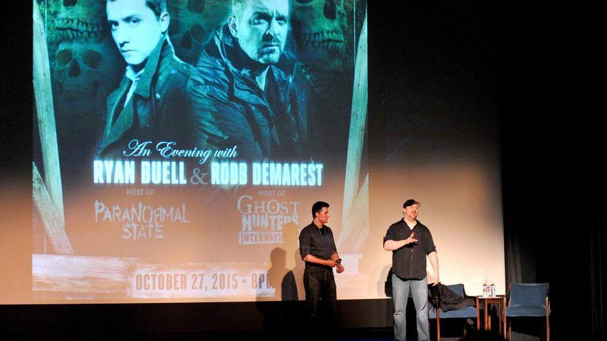 Penn State alum Ryan Buell, left, and Robb Demarest discuss their experiences investigating the supernatural during a lecture Tuesday at the State Theatre. Buell hosted six seasons of A&E’s “Paranormal State,” which was based at University Park.
