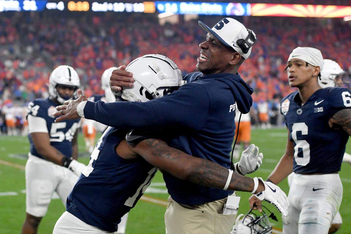 Penn State safeties coach Anthony Poindexter hugs Tyrece Mills after he intercepted the ball at the end of the Fiesta Bowl on Tuesday, Dec. 31, 2024 at State Farm Stadium.