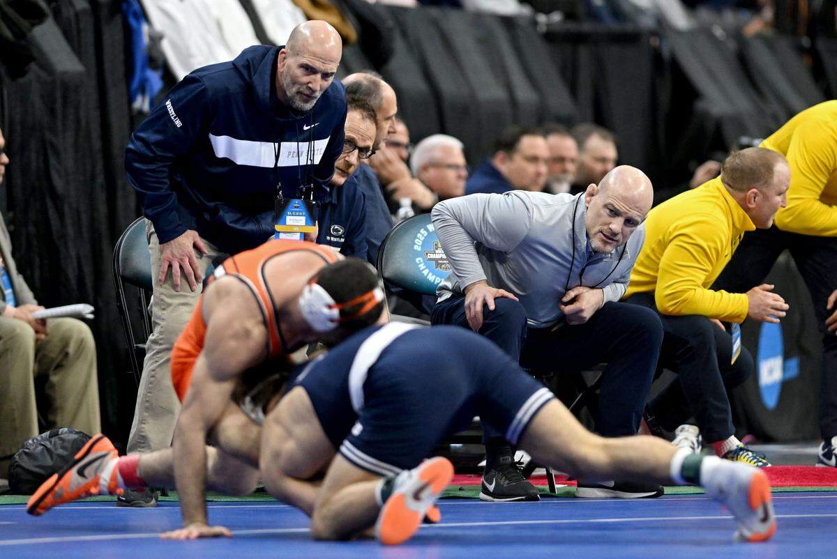 Penn State wrestling coaches Casey Cunningham and Cael Sanderson yell to Mitchell Mesenbrink during his quarterfinal bout at the 2025 NCAA Wrestling Championships in Philadelphia on Friday, March 21, 2025.