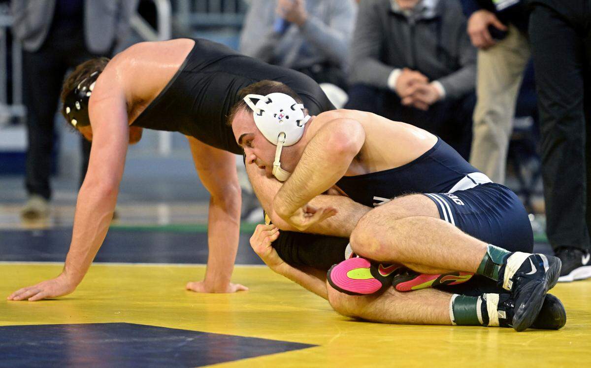 Iowa’s Jacob Warner tries to get away from Penn State’s Max Dean in a 197 lb semifinal bout of the Big Ten wrestling championships at the Crisler Center on Saturday, March 4, 2023.