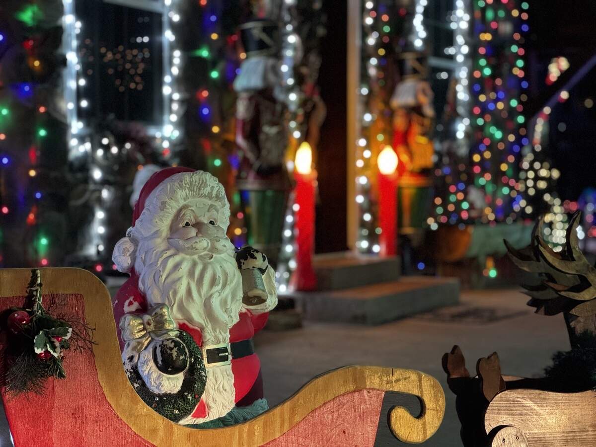 A small ceramic Santa Claus is among the decorations at 157 Oklawaha St., Milesburg, that are not lit.