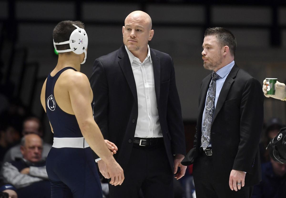 Penn State wrestling coach Cael Sanderson talks to 149 lb wrestler Luke Gardner during a blood time of his bout against Penn on Sunday, Dec. 8, 2019.