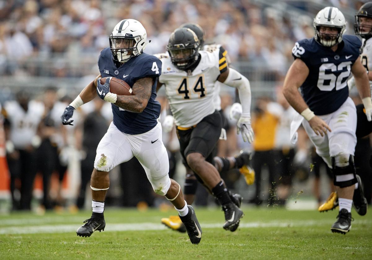 Penn State running back Ricky Slade runs for a touchdown ahead of Appalachian State defenders during the Saturday, Sept. 1, 2018 game at Beaver Stadium.