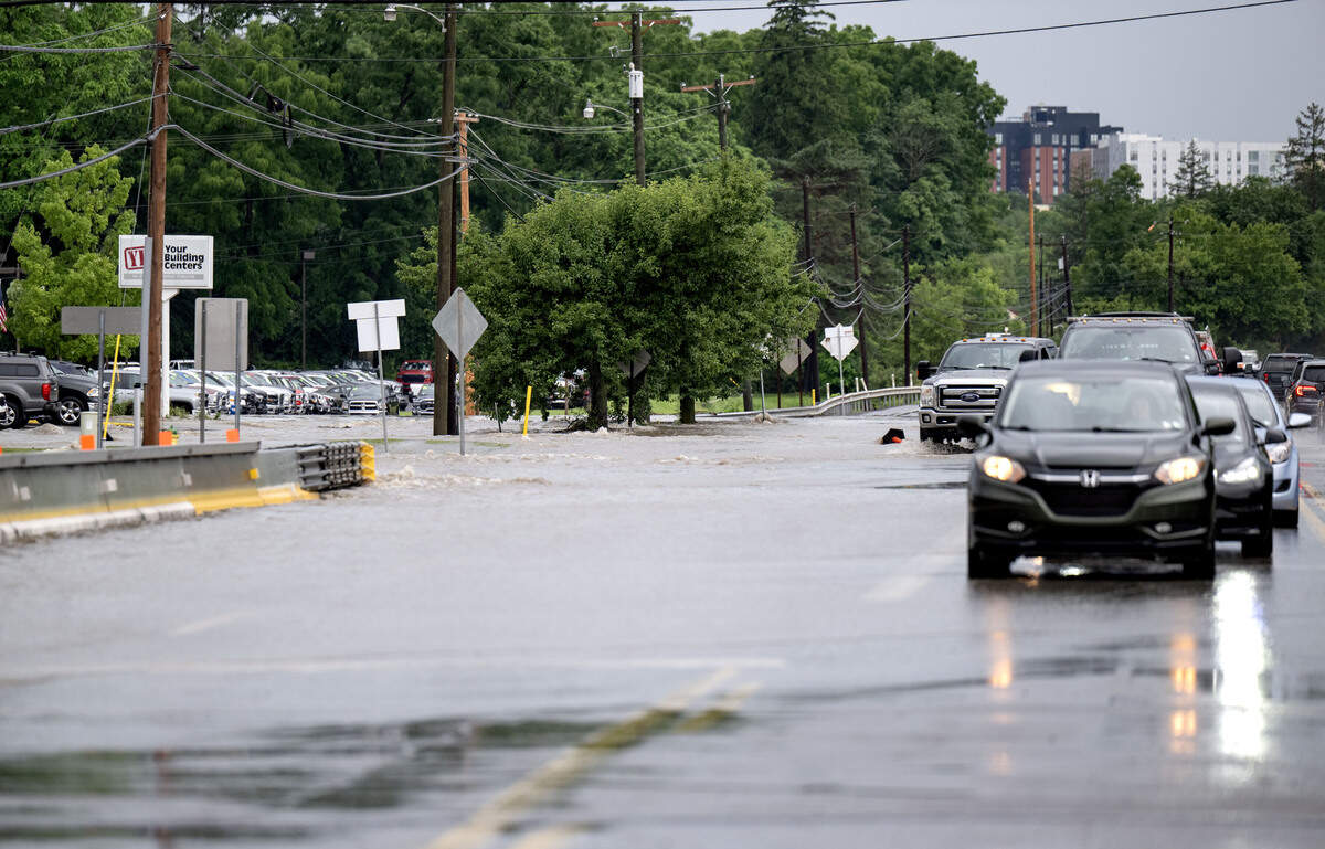 The creek floods onto College Avenue in the area of the Blaise Alexander dealer and Your Building center on Friday July 10, 2026 after a heavy storm.