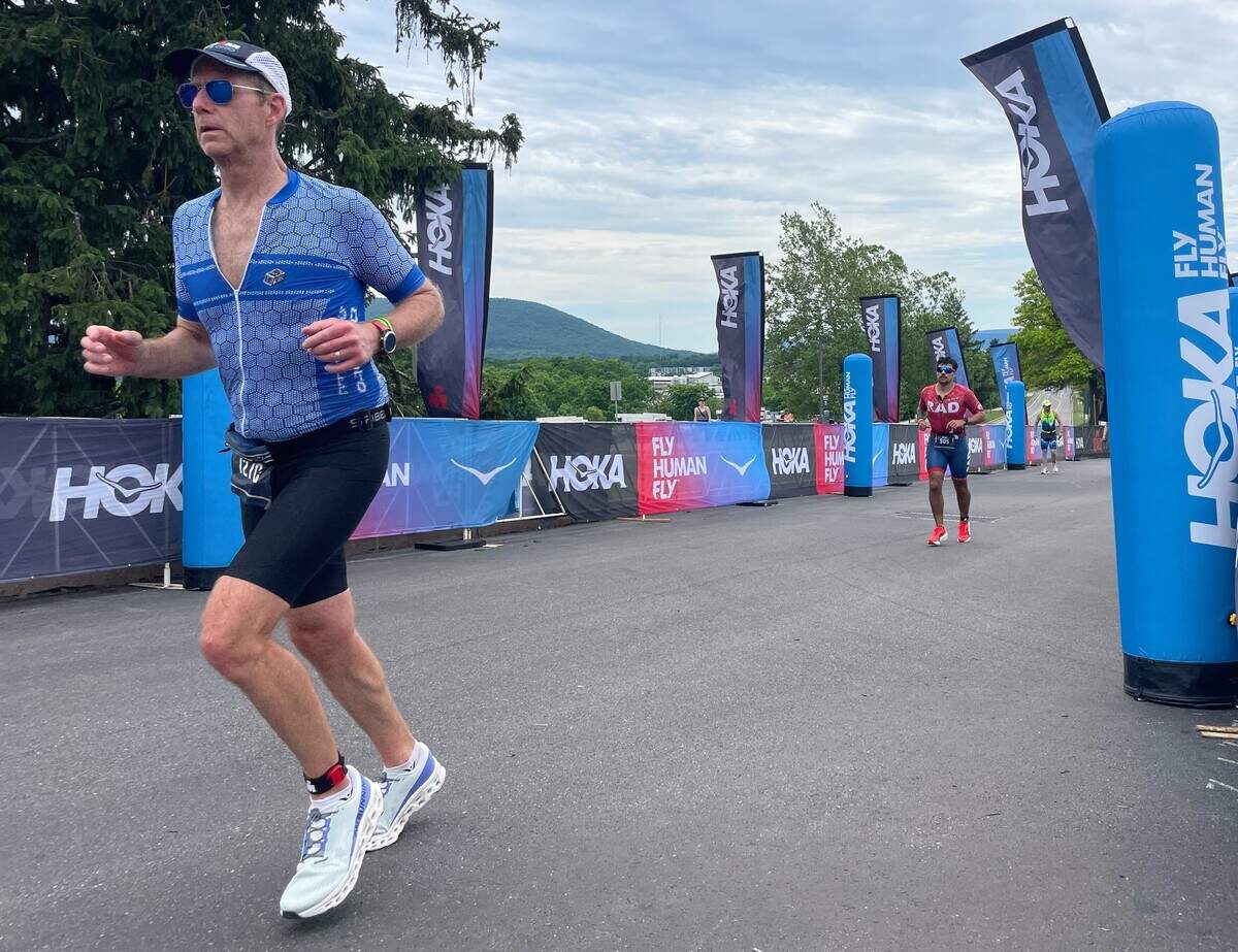 Lars Mead (front) and another runner near the finish line Sunday, June 14, 2026, at the Ironman 70.3 Pennsylvania Happy Valley North American Championship in Centre and Clinton counties.