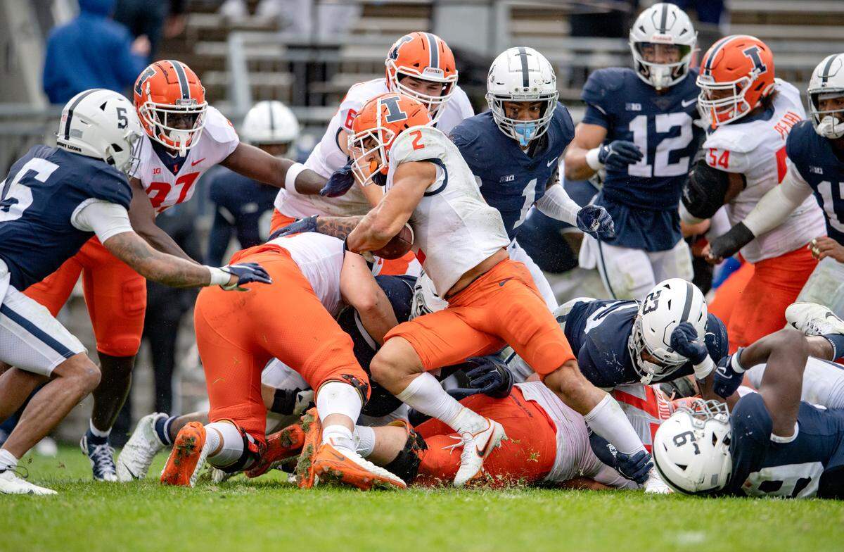 Illinois running back Chase Brown cuts through Penn State defenders to score a touchdown during the game on Saturday, Oct. 23, 2021.