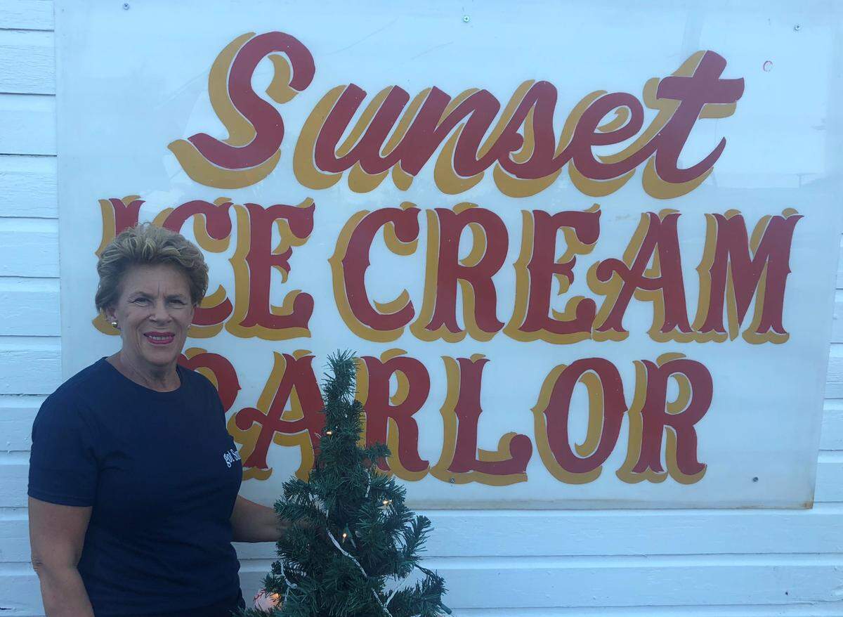Jane Pennington, owner of Sunset Ice Cream, poses in front of her parlor on Sharer Avenue on Wednesday at the Centre County Grange Encampment and Fair.
