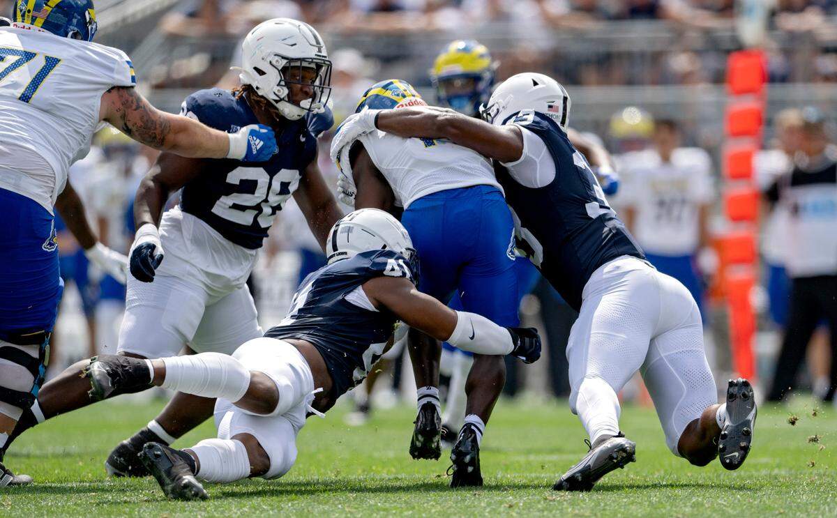 Penn State linebacker Kobe King and defensive end Dani Dennis-Sutton Stop Delaware’s Kyron Cumby during the game on Saturday, Sept. 9, 2023.