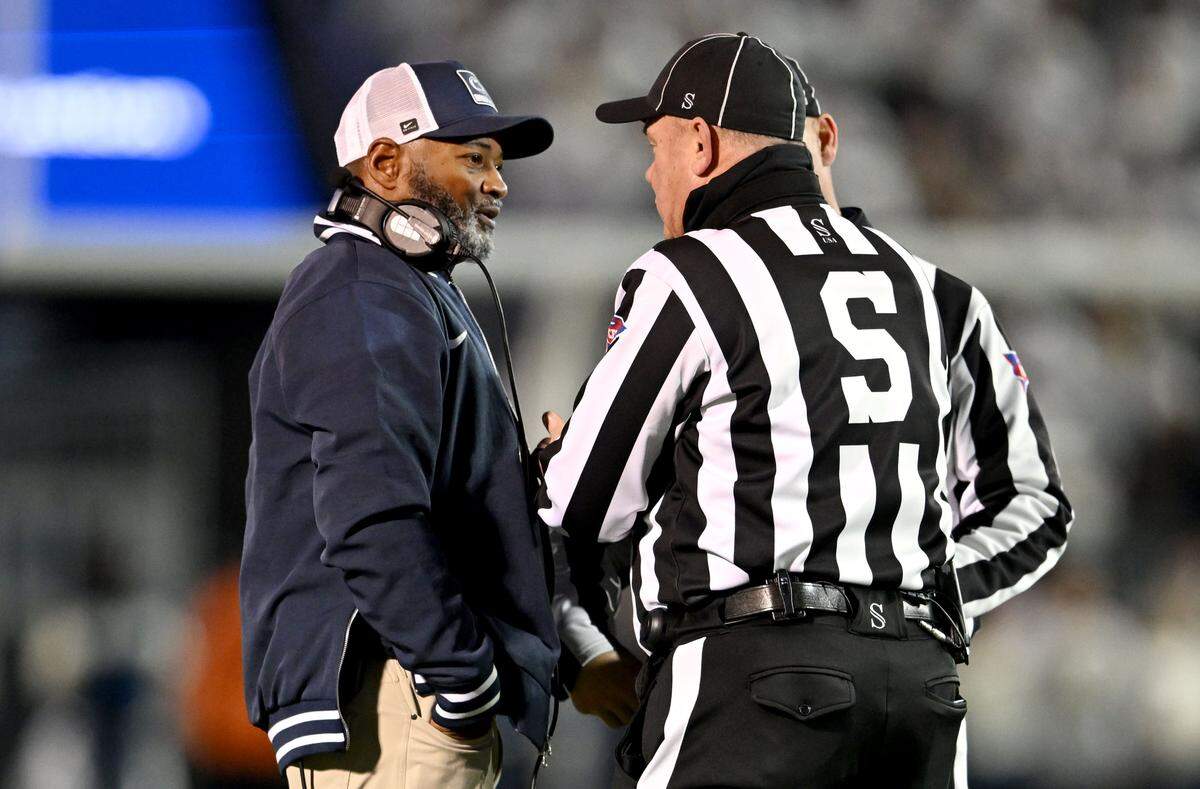 Penn State interim coach Terry Smith talks with the referees about a call during the game against Nebraska on Saturday, Nov. 22, 2025, at Beaver Stadium.  