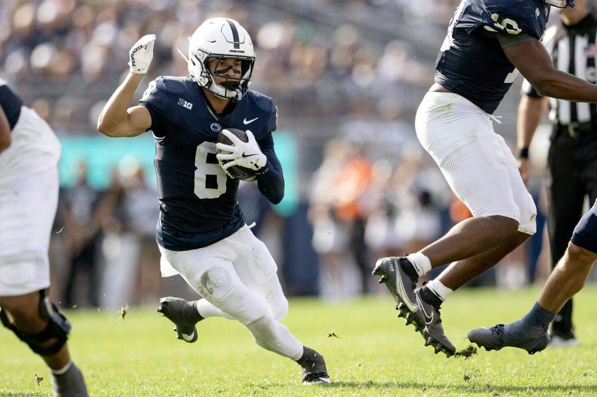 Penn State wide receiver Trebor Peña cuts down the field with the ball from Villanova defenders during the game on Saturday, Sept. 13, 2025.  