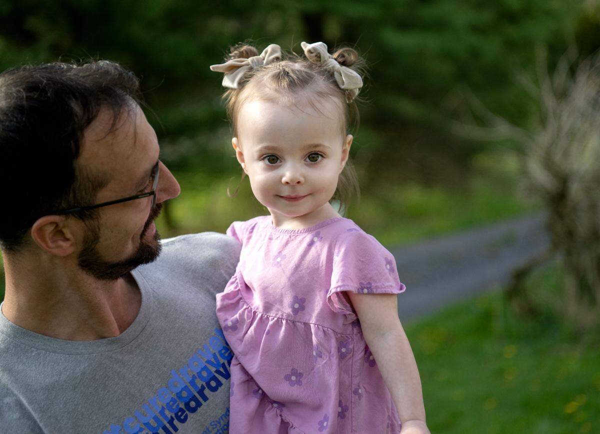 Freya Barragan smiles as she plays outside with her dad Adrian on Tuesday, April 30, 2024. Freya has Dravet syndrome, which causes seizures.