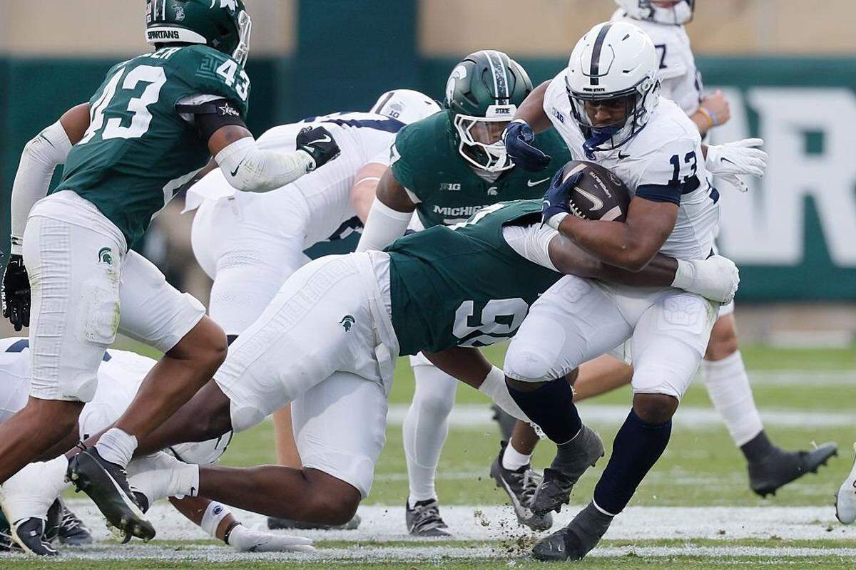 EAST LANSING, MICHIGAN -  NOVEMBER 15: Kaytron Allen #13 of the Penn State Nittany Lions is tackled by Quindarius Dunnigan #99 of the Michigan State Spartans during the first half at Spartan Stadium on November 15, 2025 in East Lansing, Michigan. (Photo by Duane Burleson/Getty Images)