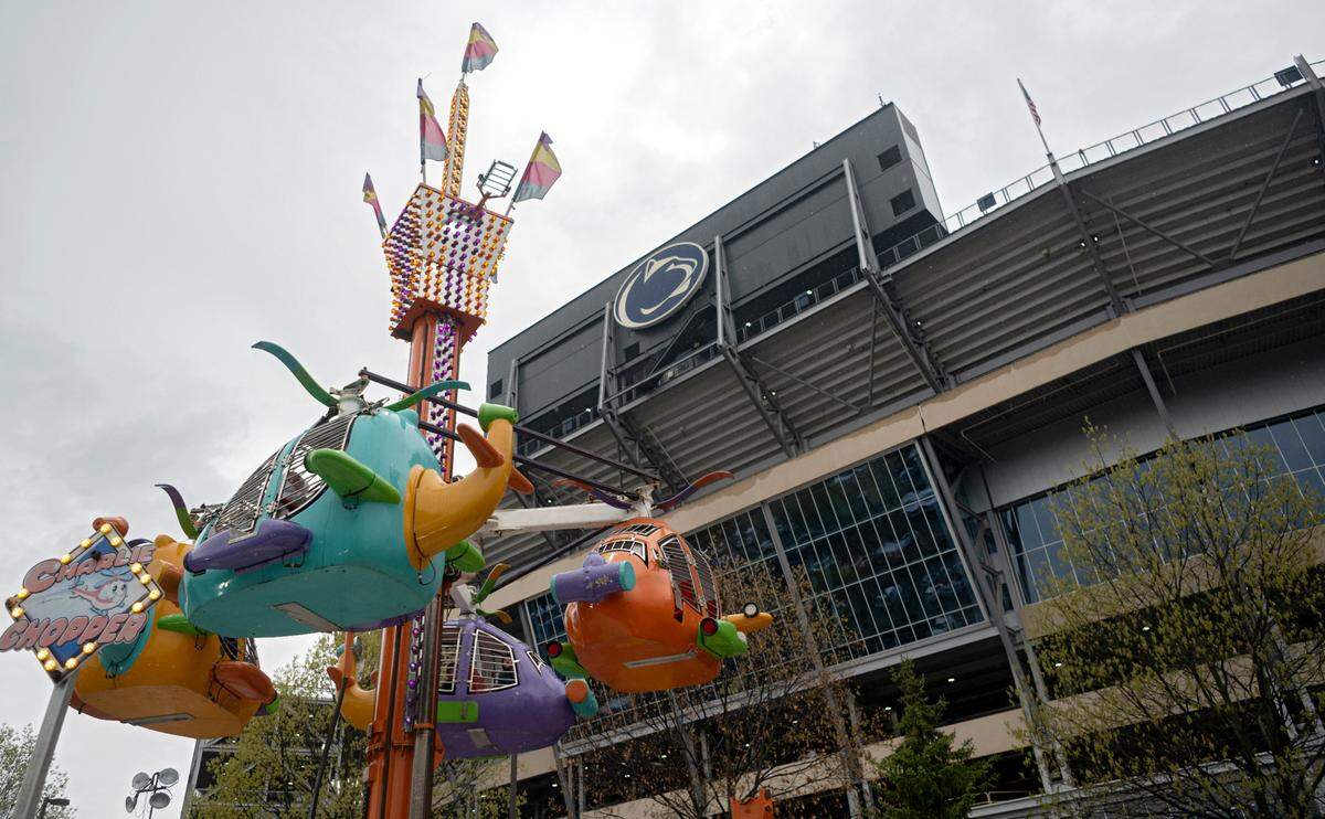 Penn State fans enjoy the rides before the Penn State Blue-White game on Saturday, April 15, 2023.