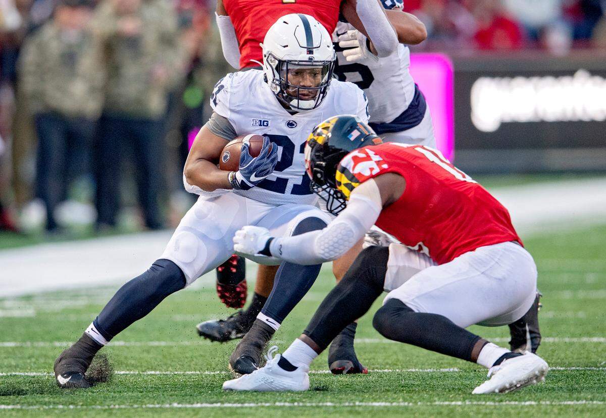 Penn State running back Noah Cain cuts around Maryland defenders during the game on Saturday, Nov. 6, 2021.