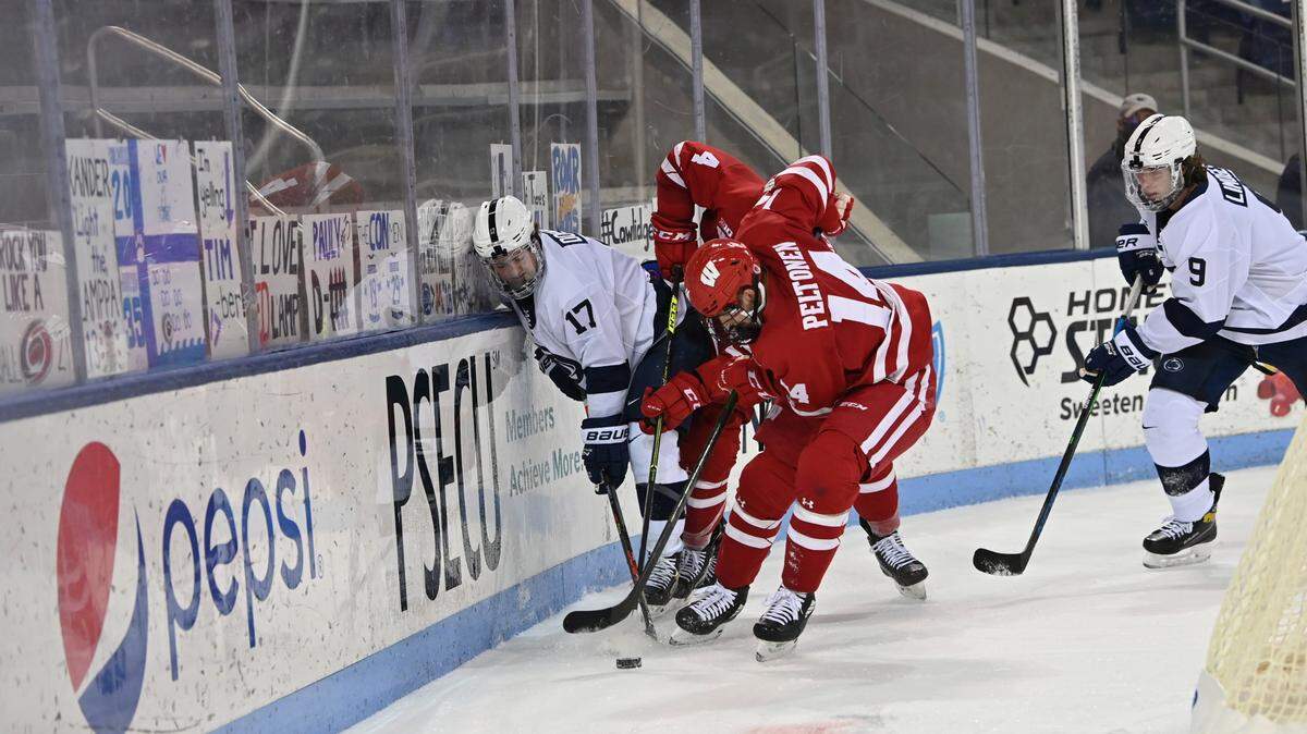 Penn State’s Tim Doherty is smashed up against the glass in the Nittany Lions’ 4-1 loss to Wisconsin Thursday night at Pegula Ice Arena.