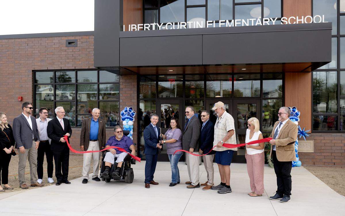 Liberty-Curtin Elementary principal Brett Umbenhouer, along with school board members for the Keystone Central School District, cuts the ribbon for the new building on Monday, Sept. 22, 2025.