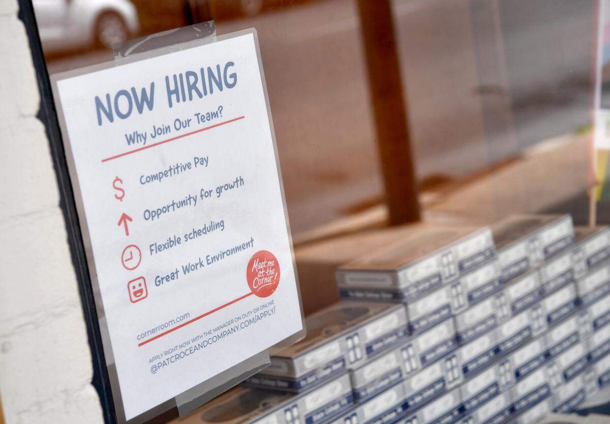 A hiring sign in the window of The Corner Room on Friday, June 18, 2021.
