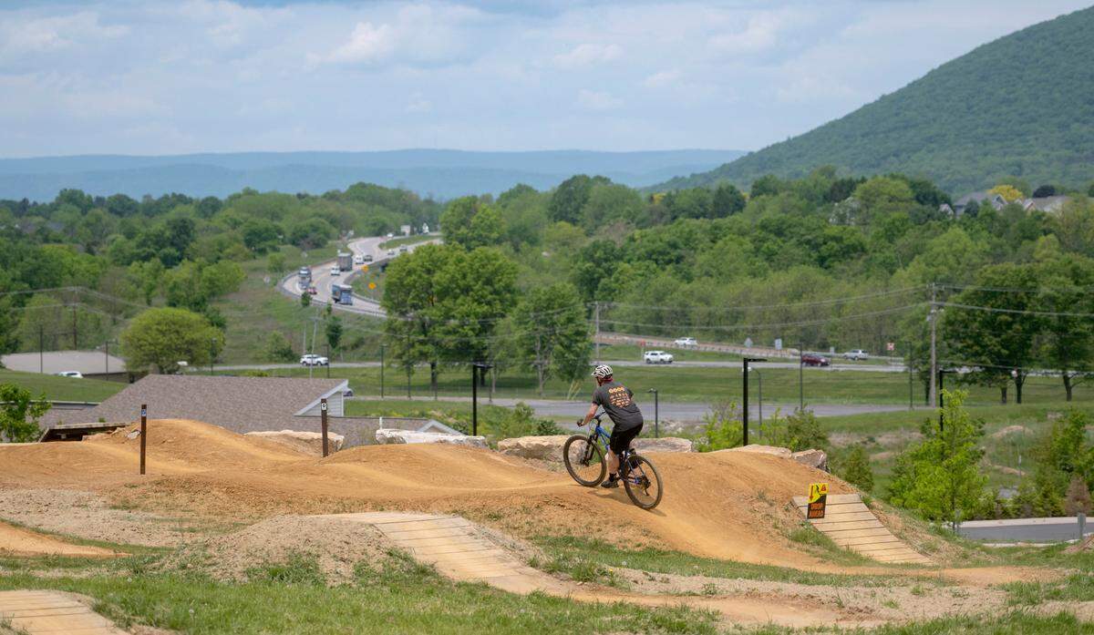 Mountain bikers enjoy the Harvest Fields community trails new skills park on Monday, May 22, 2023.
