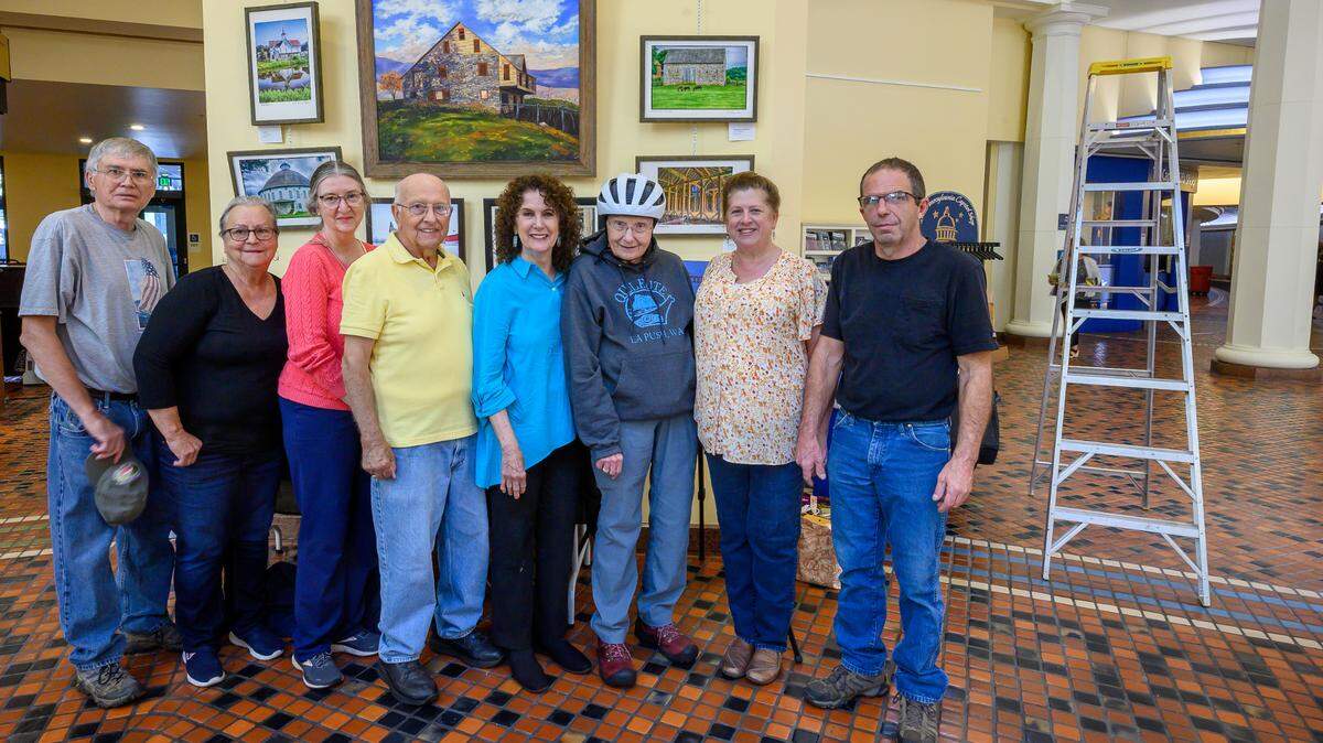 Members of the Farmland Preservation Artists of Central Pennsylvania, aided by two spouses, hung their show in the East Rotunda. Pictured from left: Elwyn Taylor, Peg Klinger, Martha Taylor, Milt Trask, Avis Jones, Barb Pennypacker, Valerie and Kim Moyer.