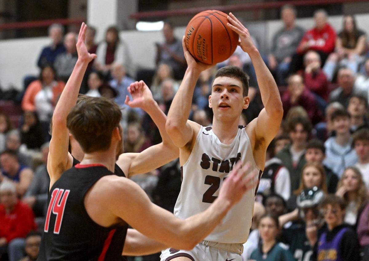 State College’s Isaac Dye goes I for a basket around Cumberland Valley defenders during the game on Tuesday, Feb. 7, 2023.