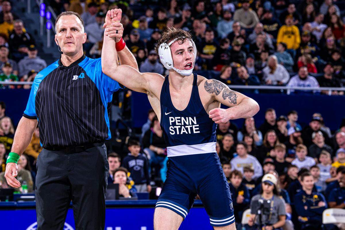 Penn State’s Nate Desmond celebrates his win at 141 pounds during the Nittany Lions’ 38-3 victory over Michigan on Friday in Ann Arbor, Mich. Desmond topped No. 26 Dylan Ragusin, 8-5, in sudden victory.