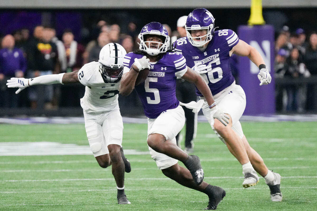 Northwestern running back Caleb Komolafe (5) runs the ball against Penn State during the second half at the new Ryan Field on Friday, Oct. 2, 2026, in Evanston, Ill.
