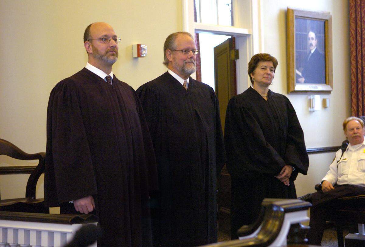 Former Centre County Judges Bradley P. Lunsford, David E. Grine, and Pamela A. Ruest during a swearing-in ceremony on Monday, January 4, 2010 at the Centre County Courthouse.