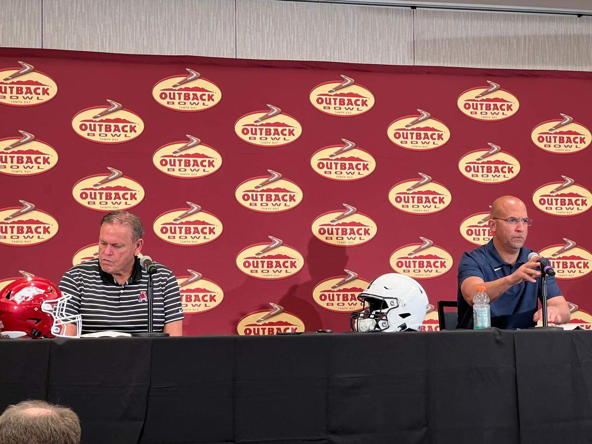 Arkansas coach Sam Pittman, left, and Penn State coach James Franklin answer questions from the media on Wednesday, Dec. 29, 2021, ahead of the Outback Bowl in Tampa, Florida.