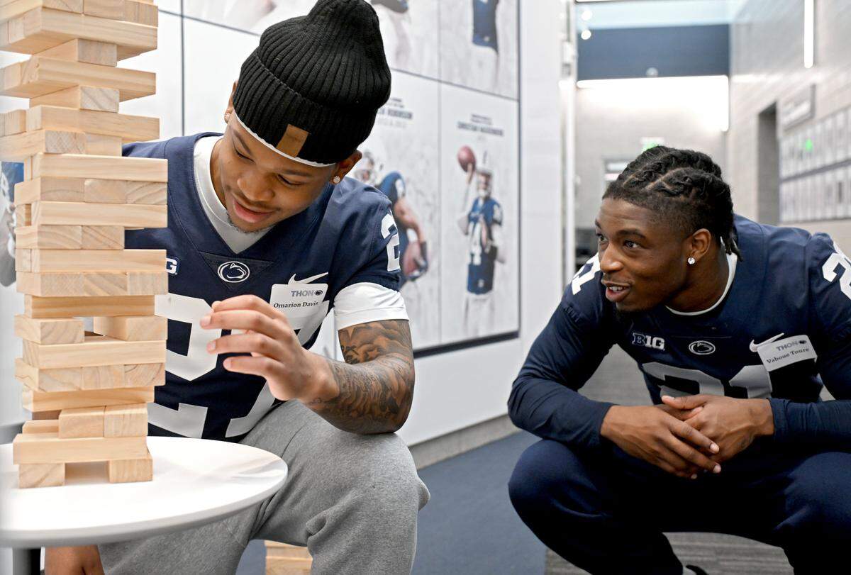 Penn State football players Omarion Davis and Vaboue Toure play an intense game of jenga during the Thon Explorers event at the Lasch Building on Saturday, Feb. 21, 2026.  