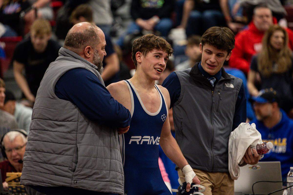 Penns Valley’s Conner Myers (center), celebrates his 127-pound title with head coach Joel Brinker (left) and assistant coach Baylor Shunk (right) during the District 6 Class 2A Championships on Saturday, Feb. 14, 2026 in Altoona.